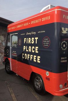 a red and black coffee truck parked in a parking lot