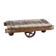 an old wooden cart with wheels on it