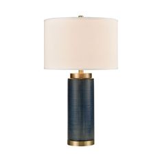 a table lamp with a white shade on it and a gold metal frame around the base