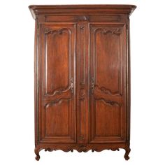 an old wooden armoire with carvings on the top and bottom, against a white background