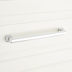 a close up of a bathroom door handle on a white wall with horizontal lines in the background