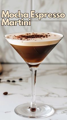 a martini glass filled with liquid and topped with chocolate sprinkled on the rim