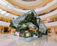 the inside of a shopping mall filled with lots of plants