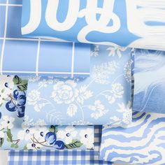 a blue and white bed spread with flowers on it