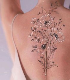 the back of a woman's body with flowers on it