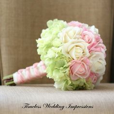 a bridal bouquet with pink and green flowers on a chair in front of a couch