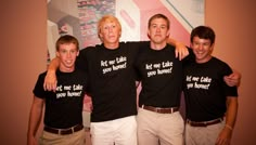 three men in black shirts are posing for a photo with their arms around each other