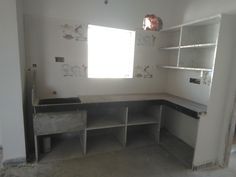 an empty room with shelves and cabinets in the middle, no one is inside or outside