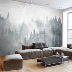 a living room filled with furniture and a large painting on the wall above it's windows