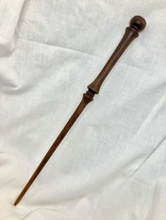 an old wooden stick is laying on a white sheet