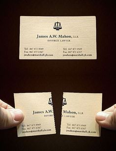 two business cards being held up in front of each other