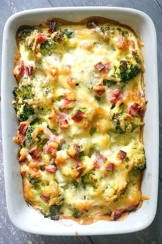 a casserole dish with broccoli, ham and cheese in it on a table