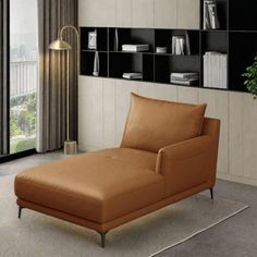 a brown chaise lounger sitting in front of a window