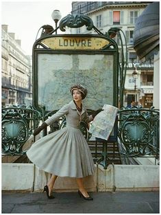 a woman is standing in front of a map