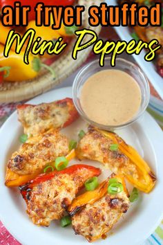 an air fryer stuffed mini peppers on a plate with dipping sauce in the background