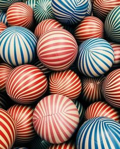 many red, white and blue balls are stacked together