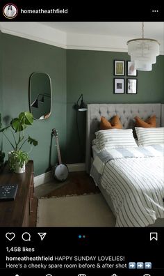 a bed room with a neatly made bed and green walls