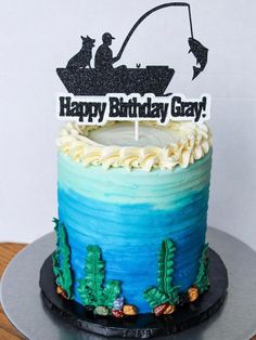 a birthday cake with a fishing scene on it and a happy birthday sign that says happy birthday gray