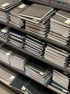 stacks of books are stacked on shelves in a store