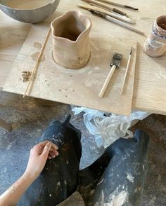 someone is working on some pottery with their feet in the process of making them look like they're doing something right now