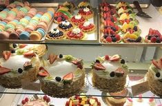 a display case filled with lots of different types of cakes