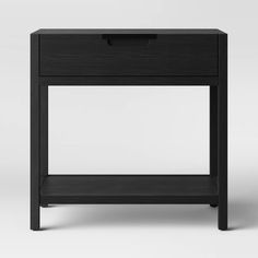 the side table is black and has a drawer on one end, and an open drawer on