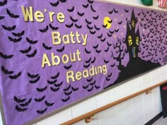 there is a batty about reading sign on the wall in this school hallway that says, we're batty about reading