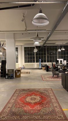 a large room with many lamps and rugs on the floor