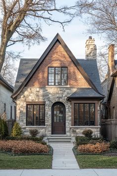 a brick and stone house in the suburbs of chicago, illinois with two front porches