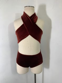 a female mannequin with a red top and brown shorts on it's torso