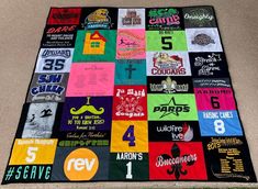 a quilt made out of t - shirts on the ground