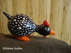 a black and white bird with polka dots on it's body sitting on a pillow