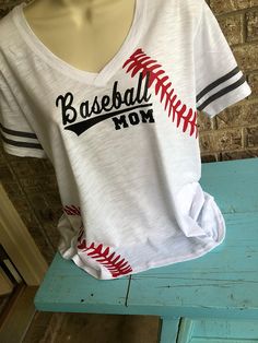 a baseball mom t - shirt sitting on top of a blue bench