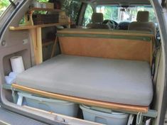 the back end of a van with an open trunk and storage area in the rear