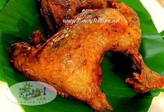 two pieces of fried chicken sitting on top of a green leaf