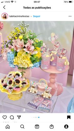 an image of a table filled with cakes and flowers on it's own screen