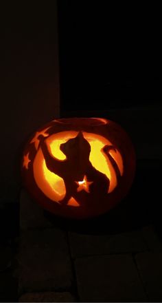 a carved pumpkin with the shape of a cat on it's face and arms