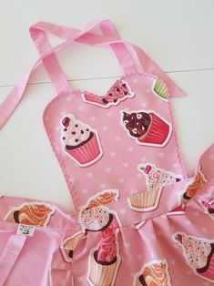 a pink apron with cupcakes on it