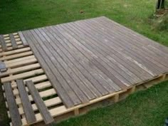 a wooden deck is being built in the yard