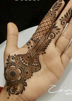 the hand is decorated with henna designs on it