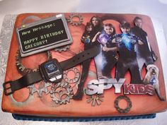 a birthday cake that is decorated with the characters from tv series spy kids on it