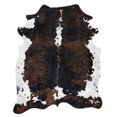 a brown and white cowhide rug on a white background