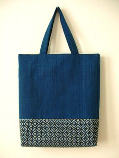 a blue tote bag hanging on the wall