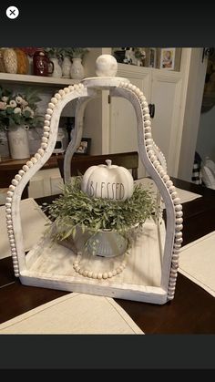 a white pumpkin sitting on top of a wooden table