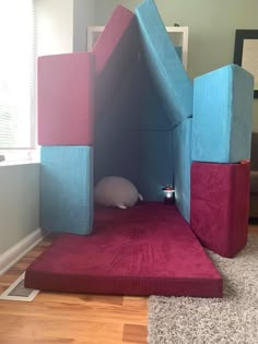 a child's bed made to look like a castle with a cat sleeping in it