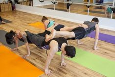 a group of people doing yoga on mats