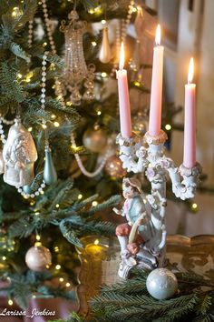 a christmas tree decorated with candles and ornaments