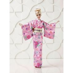 a barbie doll dressed in a pink kimono with flowers on it's sleeves