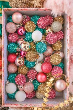 a box filled with lots of different colored ornaments