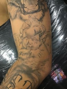 a person with a tiger tattoo on their arm and the word family written in black ink